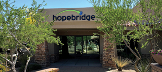 A building exterior with Hopebridge logo signage over the front door