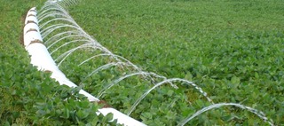 A heavy equipment operator moving a large coiled piece of material